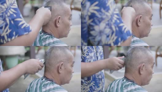 亚洲男子正在修剪亚洲高级男子头上的头发。高清在线视频素材下载