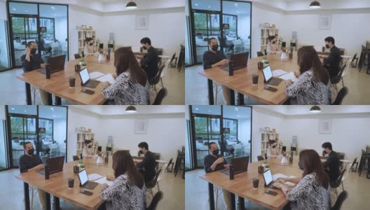 亚洲商务人士戴着口罩在办公室工作高清在线视频素材下载