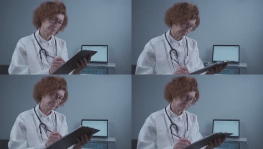 集中女医生放射科医生在登记簿上写文章，在诊所办公室工作。有资格的老年专业医生开药治疗疾病，处理文书工作高清在线视频素材下载
