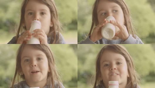 3岁的孩子在一个美丽的夏天早晨在门廊享受牛奶高清在线视频素材下载