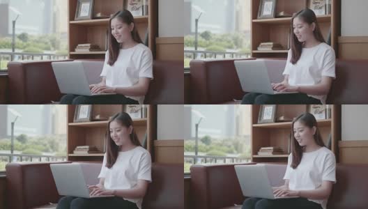 亚洲年轻人在喝咖啡休息时间用笔记本电脑高清在线视频素材下载