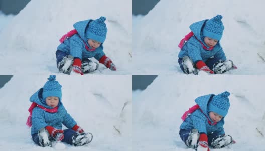 孩子坐在雪地里高清在线视频素材下载
