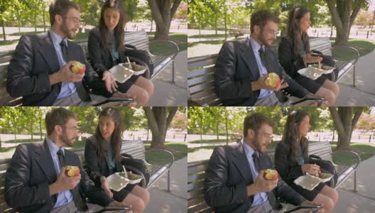 一男一女在吃健康午餐，在平板电脑上讨论一些事情高清在线视频素材下载
