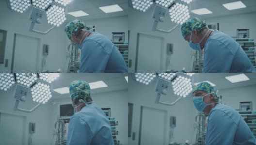 成熟的男性外科医生在ICU照明下手术高清在线视频素材下载