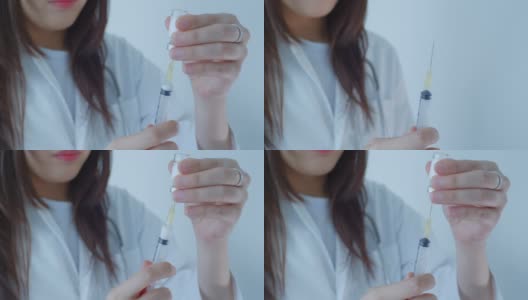 特写:亚洲女医生正在准备注射器，慢镜头高清在线视频素材下载