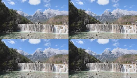 中国云南省丽江玉龙山白水河上的白瀑布高清在线视频素材下载