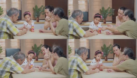 三代快乐的亚洲家庭在家里的客厅玩棋盘游戏高清在线视频素材下载