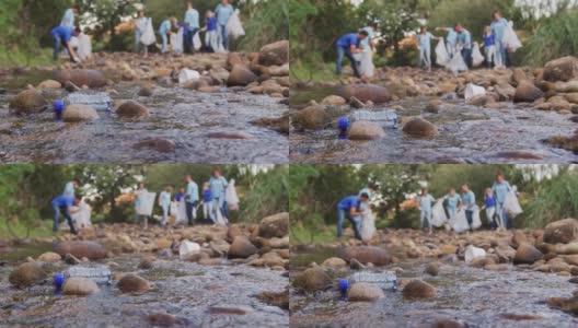 中年人在河流清理日做义工高清在线视频素材下载