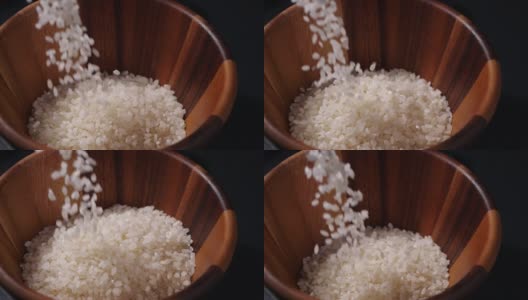 缓慢下落的日本大米。木碗里的生米粒高清在线视频素材下载