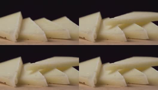 一块硬奶酪落入一堆切片羊奶酪的特写镜头。微距镜头高清在线视频素材下载