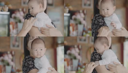 年轻的亚洲妈妈抱着她可爱的儿子高清在线视频素材下载