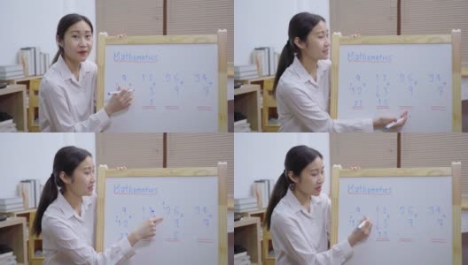 亚洲女教师在白板上写字，在家使用笔记本电脑进行在线教学高清在线视频素材下载