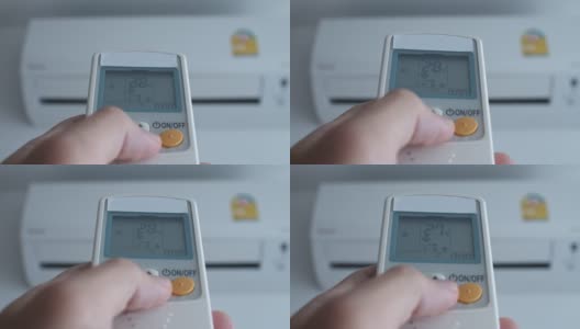 用遥控器将温度降低到25度。高清在线视频素材下载