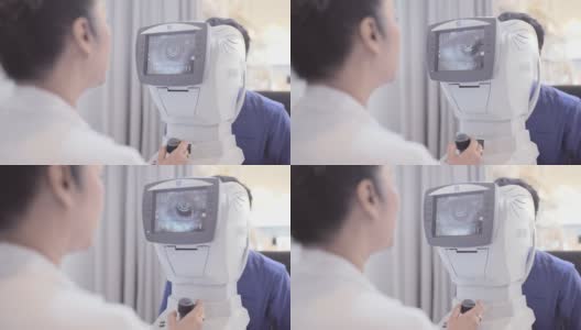 成熟的女性验光师在老年病人身上使用光视仪高清在线视频素材下载