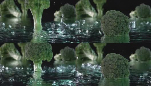 绿色的西兰花落在水面与水在黑色的飞溅气泡高清在线视频素材下载