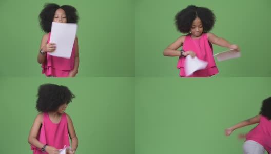 年轻可爱的非洲女孩与非洲式的头发撕裂文书工作高清在线视频素材下载