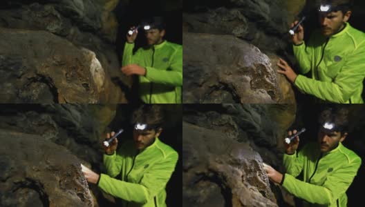 男性徒步旅行者探索黑暗的洞穴，4k高清在线视频素材下载