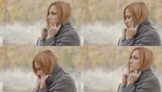 沮丧悲伤的女人肖像与秋天的树在背景高清在线视频素材下载
