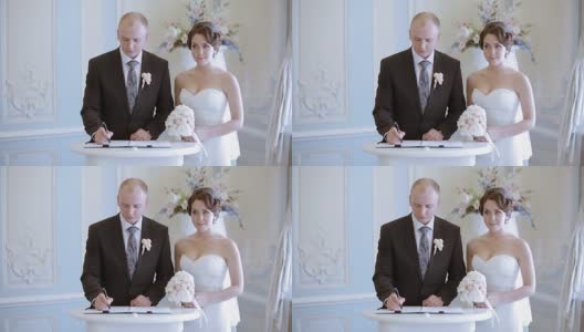美丽的新娘和英俊的新郎正在登记结婚高清在线视频素材下载