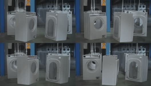 在现代化的工厂里，洗衣机的机壳在自动传送带上移动高清在线视频素材下载