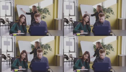 在男女经理面前交谈，解决问题，使用笔记本电脑高清在线视频素材下载