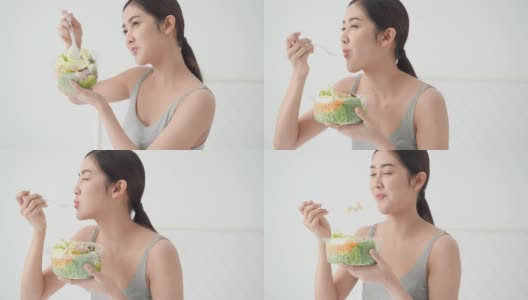 美丽的亚洲女孩吃解毒蔬菜和水果。漂亮女孩拿着水果沙拉和排毒食品。健身、保健、饮食的概念。高清在线视频素材下载