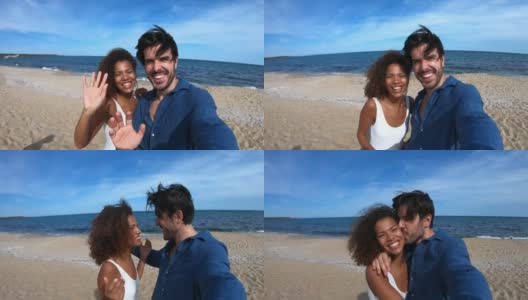 一对情侣在海滩上用智能手机制作视频高清在线视频素材下载