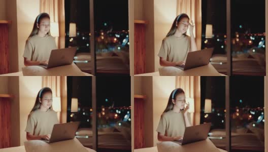 美女戴着面膜在笔记本电脑上玩社交媒体。高清在线视频素材下载