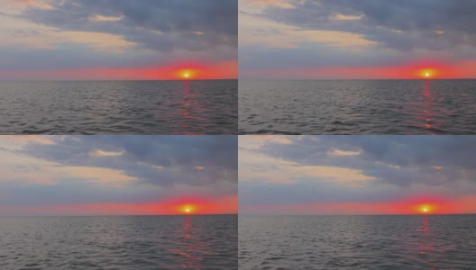 傍晚橙黄色的日落在湖面的地平线上高清在线视频素材下载
