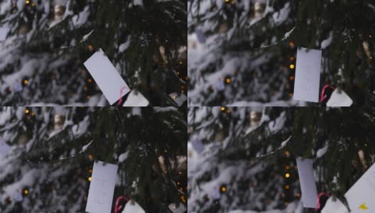 圣诞老人的祝福信挂在户外的圣诞树上高清在线视频素材下载