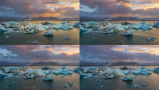 4k时间推移日落场景移动的云与蓝色冰山漂浮在Jokulsarlon冰川泻湖，冰岛高清在线视频素材下载