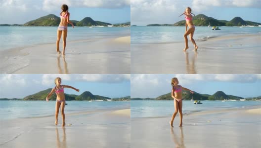 活泼的小女孩在白色沙滩上翻跟斗高清在线视频素材下载