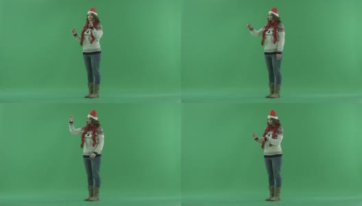 戴着圣诞帽的严肃年轻女子在增强现实中做手势，背景上有色度键高清在线视频素材下载