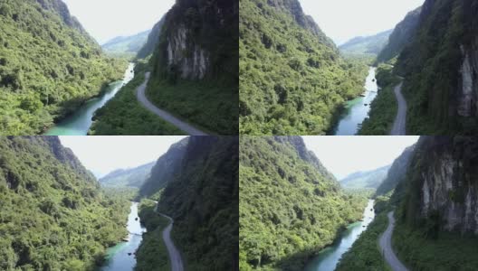 道路和河流在陡峭郁郁葱葱的森林两岸之间蜿蜒曲折高清在线视频素材下载