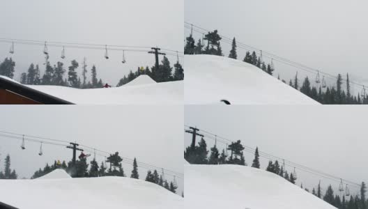 完成一个“驾驶室900开关尾巴”技巧与森林和滑雪缆车在背景在科罗拉多州博尔德附近的埃尔多拉滑雪度假村在一个下雪的，阴天从远处高清在线视频素材下载