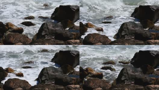 在加州旧金山的海洋海滩，海浪拍打着悬崖岩石的风景。泡沫的水，明亮的阳光高清在线视频素材下载