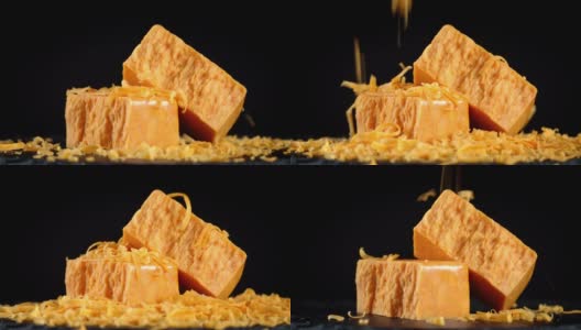 小块磨碎的切达干酪掉在桌上。高清在线视频素材下载