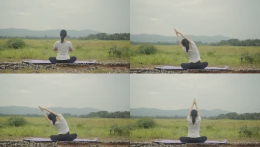 美丽的白人女性坐在冥想姿势姿势瑜伽调呼吸平衡在美丽的山景在早上。高清在线视频素材下载