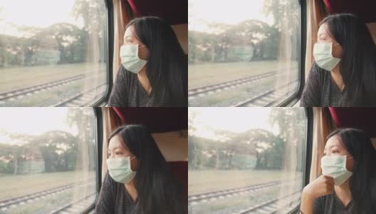 亚洲女性戴口罩乘坐火车小心乘坐公共交通工具。4 k慢动作。高清在线视频素材下载