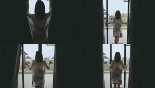 亚洲女子拉开窗帘走出泳池别墅度假区的房间高清在线视频素材下载