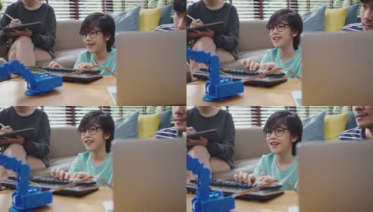 亚洲的孩子们用笔记本电脑给机器人起重机编程，让它们学习科技、数学和工程学。在家编程和编码高清在线视频素材下载