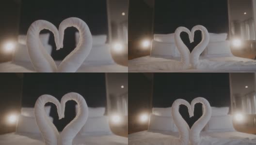 在浪漫的酒店房间床上叠成天鹅形的毛巾高清在线视频素材下载