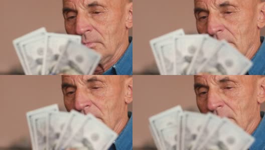 老年人与金融主题。一名70多岁的白人老人在数钞票。退休年龄，退休金分配。爷爷手里有美元。有选择性的重点,高清在线视频素材下载