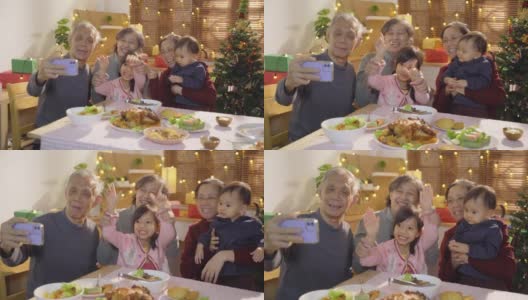 快乐和快乐的亚洲家庭在新年前夕节日问候和聚集在一起使用智能手机自拍和视频通话在团圆饭高清在线视频素材下载