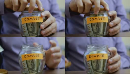 一个白人把一个玻璃罐和他的积蓄放在抽屉里捐了高清在线视频素材下载