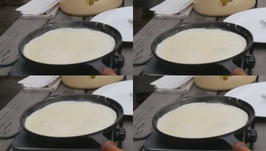用来煎生面团做薄饼的大煎锅。Maslenitsa节日，斯拉夫人春季聚会的重要庆祝活动，街头美食节高清在线视频素材下载