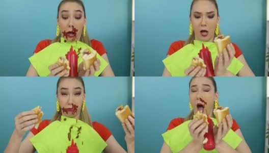 这名女子正在吃蘸了番茄酱的热狗高清在线视频素材下载