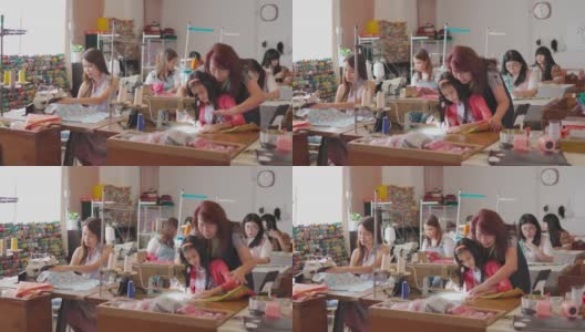 亚洲华人成熟女性裁缝在她的工作室里教她的缝纫班学生缝纫技巧高清在线视频素材下载