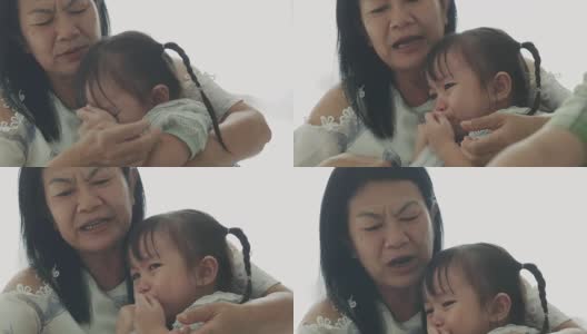 泰国小女孩在妈妈和弟弟旁边哭，失望和愤怒的感觉高清在线视频素材下载