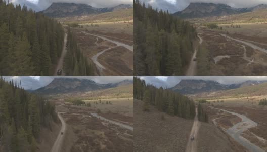 空中黑色越野车行驶在道路槽河谷向落基山脉高清在线视频素材下载